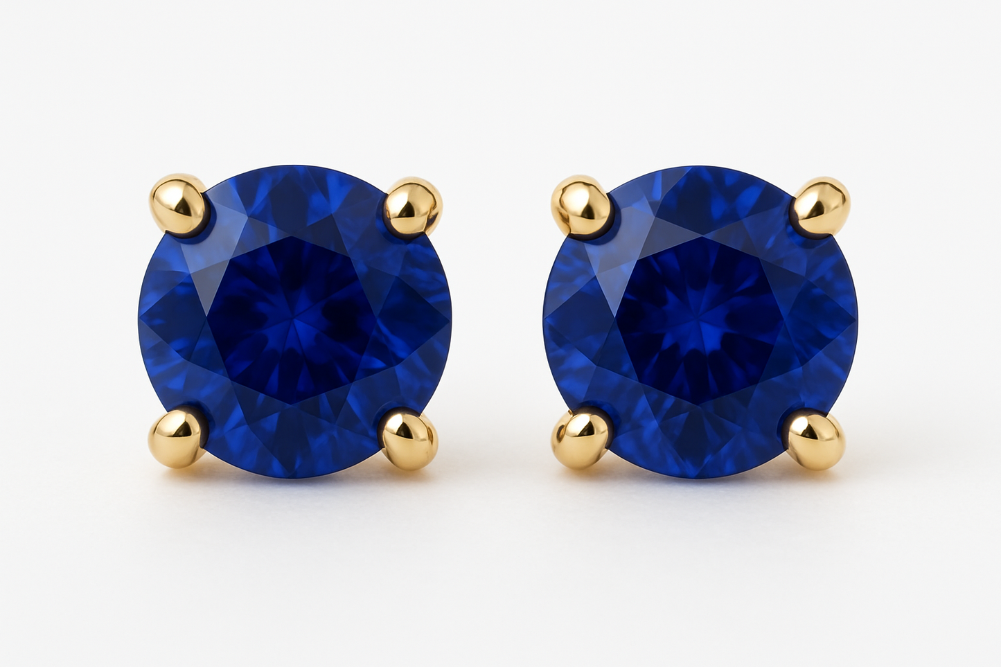 Round blue sapphire studs in 4 prong yellow gold setting